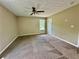 Spacious carpeted bedroom with a ceiling fan and window for natural light at 186 Grapevine Dr, Douglasville, GA 30134