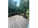 Wooden deck and railing with leafy green surroundings at 186 Grapevine Dr, Douglasville, GA 30134