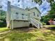 Charming home features a white exterior with a quaint front porch and a well-maintained lawn at 186 Grapevine Dr, Douglasville, GA 30134