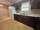 Practical kitchen with refrigerator, dark cabinets, and stainless steel sink at 186 Grapevine Dr, Douglasville, GA 30134
