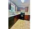 The kitchen features tile floors, black appliances, and wood cabinetry at 186 Grapevine Dr, Douglasville, GA 30134