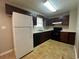 Charming kitchen featuring dark wood cabinetry and modern appliances at 186 Grapevine Dr, Douglasville, GA 30134
