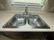 A stainless steel kitchen sink with chrome faucet and laminate countertops at 186 Grapevine Dr, Douglasville, GA 30134