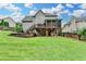 Expansive backyard featuring a multilevel deck and lush green lawn, perfect for outdoor activities at 3760 Ansley Park Dr, Suwanee, GA 30024