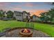 Cozy backyard has a brick firepit and a well-maintained lawn, perfect for entertaining and outdoor gatherings at 3760 Ansley Park Dr, Suwanee, GA 30024