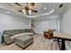 Finished basement with comfortable seating, a rolling wood-topped table, and wood floors at 3760 Ansley Park Dr, Suwanee, GA 30024