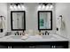 Bright bathroom features double sinks, quartz counters, black hardware, and modern fixtures at 3760 Ansley Park Dr, Suwanee, GA 30024