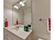 Bright bathroom features a large vanity, mirror, modern lighting and stylish accessories at 3760 Ansley Park Dr, Suwanee, GA 30024