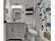 Charming bathroom with classic gray vanity and fun dinosaur shower curtain at 3760 Ansley Park Dr, Suwanee, GA 30024
