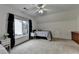 Large bedroom with dormer window, patterned duvet, and hardwood floor at 3760 Ansley Park Dr, Suwanee, GA 30024