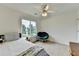 Bright bedroom with a ceiling fan and a large window overlooking the front yard at 3760 Ansley Park Dr, Suwanee, GA 30024