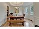 Charming dining room featuring a chandelier, hardwood floors, and bay windows at 3760 Ansley Park Dr, Suwanee, GA 30024