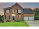 Charming two-story brick home with a well-manicured lawn and a two-car garage, located in a suburban neighborhood at 3760 Ansley Park Dr, Suwanee, GA 30024