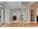 Bright foyer with hardwood floors, featuring french doors that lead into the home's living spaces at 3760 Ansley Park Dr, Suwanee, GA 30024