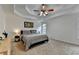 Comfortable main bedroom featuring a tray ceiling, soft carpeting and a tranquil atmosphere at 3760 Ansley Park Dr, Suwanee, GA 30024