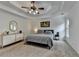 Spacious main bedroom with a tray ceiling, neutral carpeting and a well-lit open space at 3760 Ansley Park Dr, Suwanee, GA 30024
