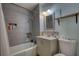 Updated bathroom featuring modern fixtures and tile, with a tub and shower combination at 493 James Street Sw, Lilburn, GA 30047