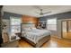 Stylish bedroom with modern wood accent wall, ceiling fan, and hard wood floors at 493 James Street Sw, Lilburn, GA 30047