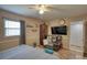 Bedroom features wood floors, and a comfortable recliner, complete with a large television at 493 James Street Sw, Lilburn, GA 30047