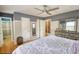 Spacious bedroom featuring stylish gray walls, hardwood flooring, and walk-in closet with built in shelving at 493 James Street Sw, Lilburn, GA 30047