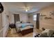 Cozy bedroom with wood floors, storage chest and ceiling fan at 493 James Street Sw, Lilburn, GA 30047