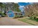 View of home, showcasing brick driveway, landscaping, and blue siding, adding to its appeal at 493 James Street Sw, Lilburn, GA 30047