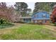 Charming two-story home with a manicured lawn and mature trees, showcasing curb appeal at 493 James Street Sw, Lilburn, GA 30047