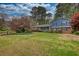 Charming two-story home with a manicured lawn and mature trees, showcasing curb appeal at 493 James Street Sw, Lilburn, GA 30047
