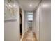 Neutral hallway leads to bathroom with white doors and decorative art at 493 James Street Sw, Lilburn, GA 30047