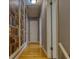 Hallway with wood flooring and bookshelf wallpaper, complete with white doors at 493 James Street Sw, Lilburn, GA 30047
