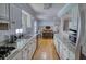Spacious kitchen with granite countertops, stainless steel appliances, and open view to dining area at 493 James Street Sw, Lilburn, GA 30047