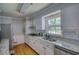 Beautiful kitchen includes modern stainless steel appliances, granite countertops, and abundant natural light at 493 James Street Sw, Lilburn, GA 30047