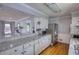 Well-lit kitchen features sleek granite countertops, ample cabinetry, and stainless steel appliances at 493 James Street Sw, Lilburn, GA 30047