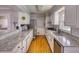 Bright kitchen features white cabinetry, granite countertops, stainless steel appliances, and tile backsplash at 493 James Street Sw, Lilburn, GA 30047