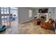 Cozy living room with fireplace, tile flooring, and access to an office through glass paneled doors at 493 James Street Sw, Lilburn, GA 30047
