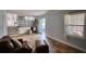 Open living space with tiled floors, a built-in bar area, stairs to upper level, and large windows at 493 James Street Sw, Lilburn, GA 30047