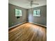 Bedroom featuring hardwood floors, a ceiling fan, and natural light from the windows at 6616 King George Way, Morrow, GA 30260