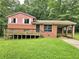 Exterior view of home featuring front yard with deck at 6616 King George Way, Morrow, GA 30260