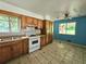 View of Kitchen with double sink, electric range, and tiled backsplash at 6616 King George Way, Morrow, GA 30260