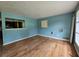 Living room featuring wood floors, blue walls, and window at 6616 King George Way, Morrow, GA 30260