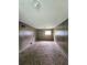 Cozy living room with carpeted flooring and wood paneled walls at 6616 King George Way, Morrow, GA 30260