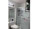 Bathroom with glass shower and a toilet with shelves at 6620 Wellington Sq, Norcross, GA 30093