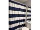 Bathroom featuring a toilet, mirror and striped shower curtain at 6620 Wellington Sq, Norcross, GA 30093