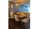 Dining room with wood table, upholstered chairs, and modern lighting at 6620 Wellington Sq, Norcross, GA 30093