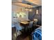 Dining room with wood table, upholstered chairs, and modern lighting at 6620 Wellington Sq, Norcross, GA 30093