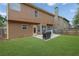 Spacious backyard featuring a well-maintained lawn and patio space, perfect for outdoor entertaining at 1267 Castleberry Dr, Buford, GA 30518