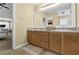 Bathroom features double sinks with wood cabinets and a large framed mirror at 1267 Castleberry Dr, Buford, GA 30518