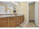 Bathroom features double sinks with wood cabinets and a large framed mirror at 1267 Castleberry Dr, Buford, GA 30518