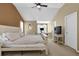 Bright bedroom with a neutral palette, featuring a vaulted ceiling, TV, and desk at 1267 Castleberry Dr, Buford, GA 30518
