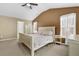 Bright bedroom with a neutral palette, featuring a vaulted ceiling and a ceiling fan at 1267 Castleberry Dr, Buford, GA 30518